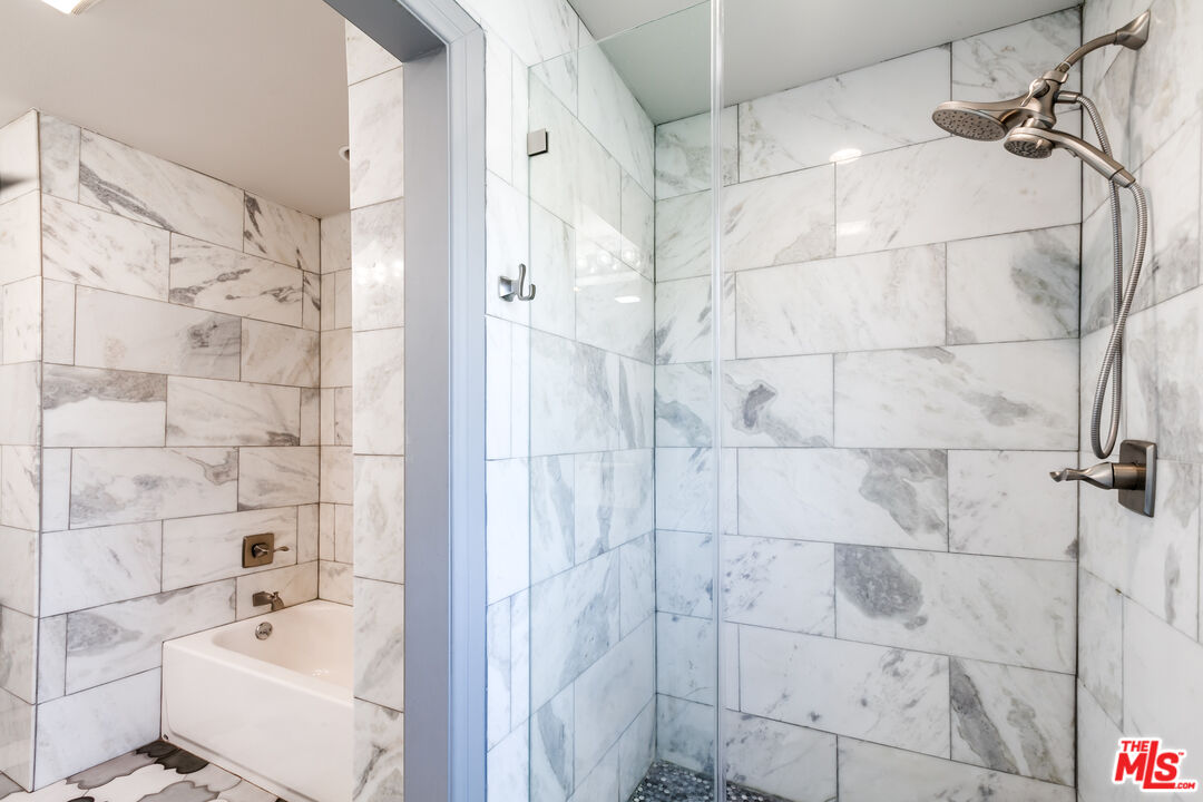 17153 Rayen Street Northridge, CA 91325 - Photo 27 of 47 a bathroom with a bathtub and shower
