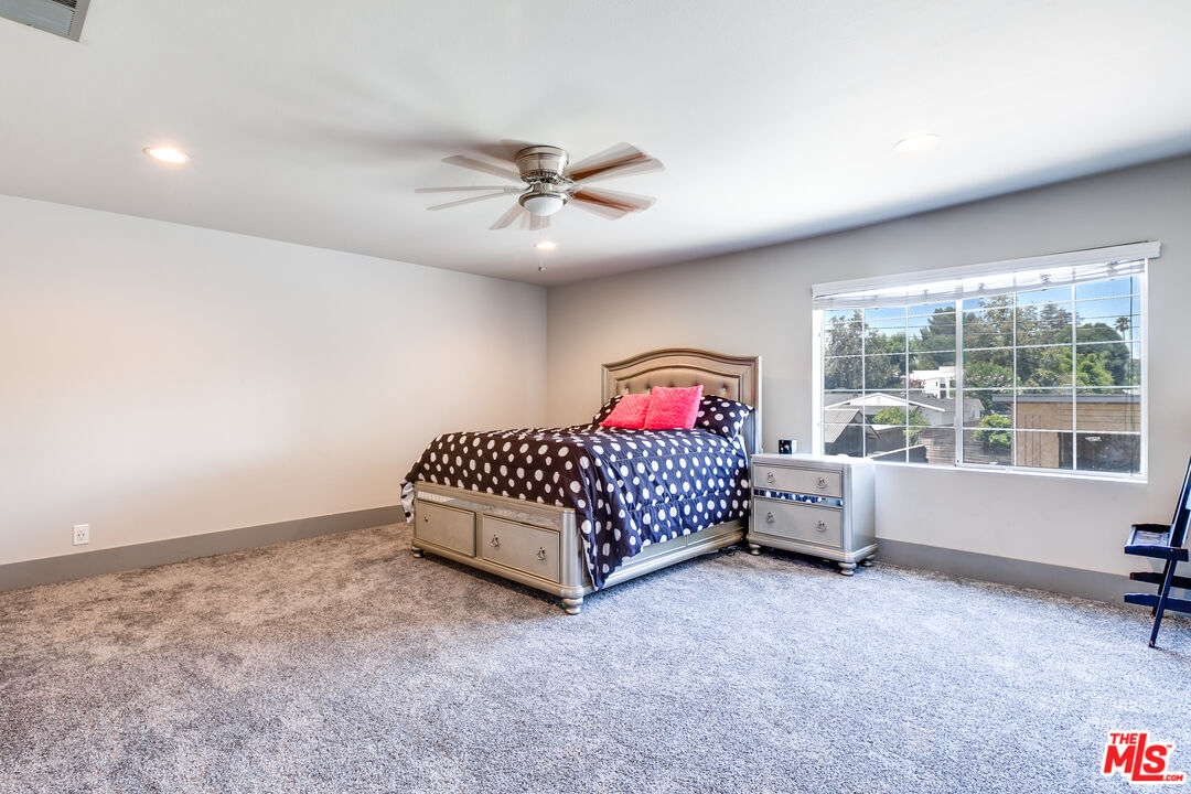 17153 Rayen Street Northridge, CA 91325 - Photo 28 of 47 a bedroom with a bed and a large window