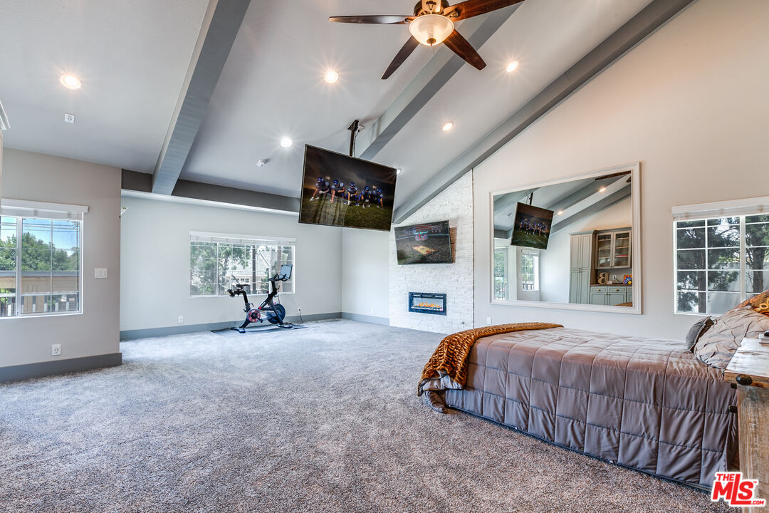 17153 Rayen Street Northridge, CA 91325 - Photo 30 of 47 a bedroom with a bed tv and a large window