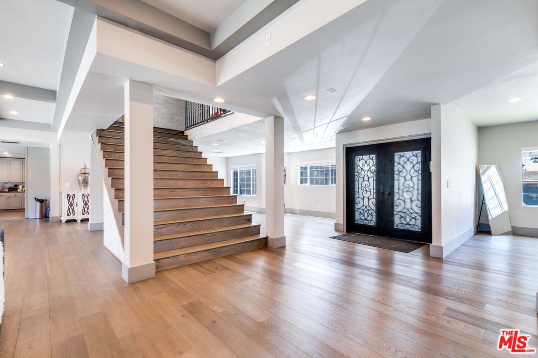 17153 Rayen Street Northridge, CA 91325 - Photo 3 of 47 a view of an entryway with wooden floor and windows