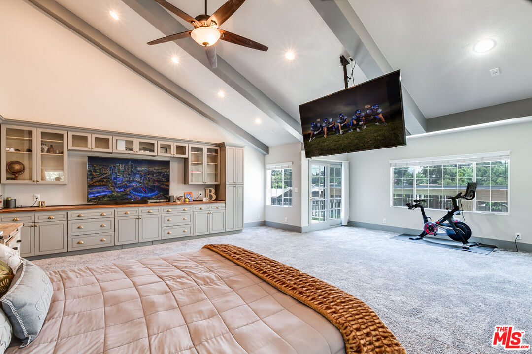 17153 Rayen Street Northridge, CA 91325 - Photo 31 of 47 a bedroom with a bed a television and a large window