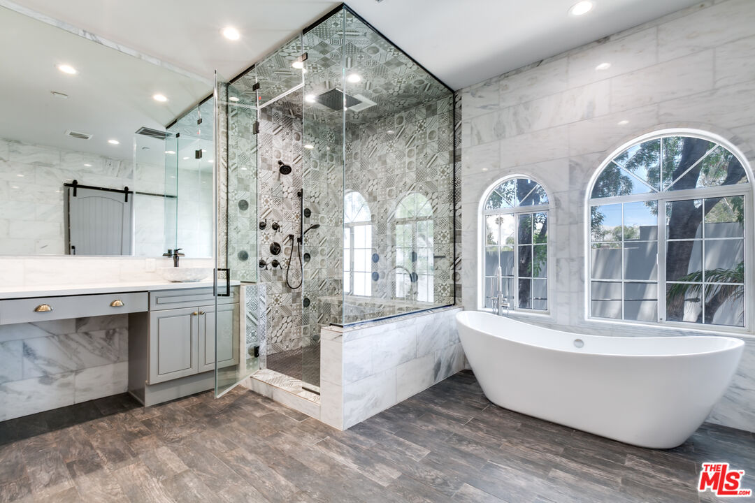 17153 Rayen Street Northridge, CA 91325 - Photo 35 of 47 a large spacious bathroom with a double vanity sink a mirror and a bathtub