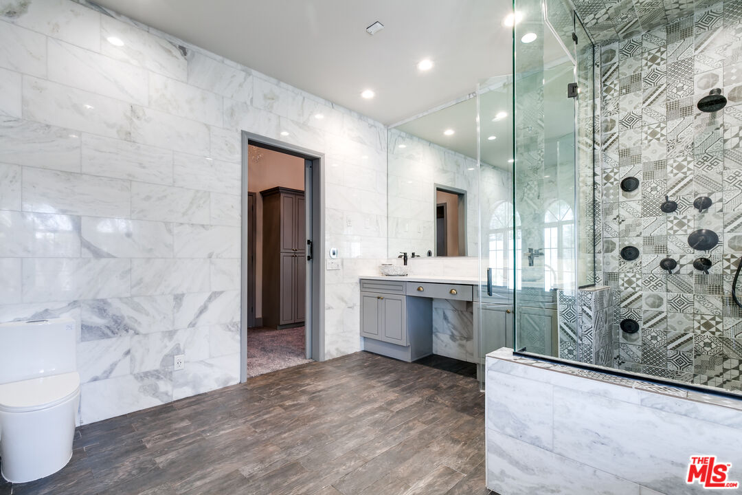17153 Rayen Street Northridge, CA 91325 - Photo 36 of 47 a bathroom with a double vanity sink toilet and shower