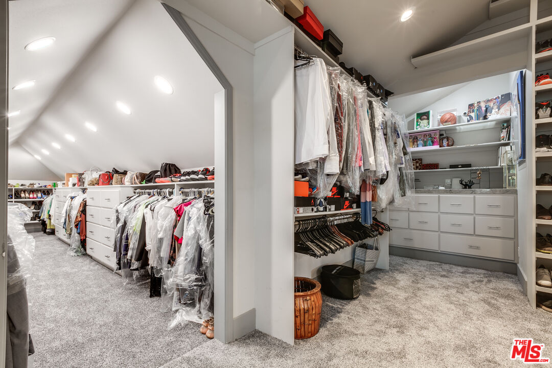 17153 Rayen Street Northridge, CA 91325 - Photo 38 of 47 a view of walk in closet with clothes and shoes