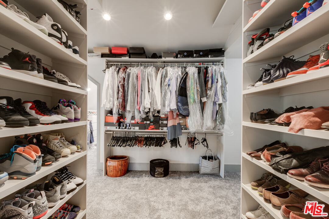 17153 Rayen Street Northridge, CA 91325 - Photo 40 of 47 a view of walk in closet with clothes and shoes