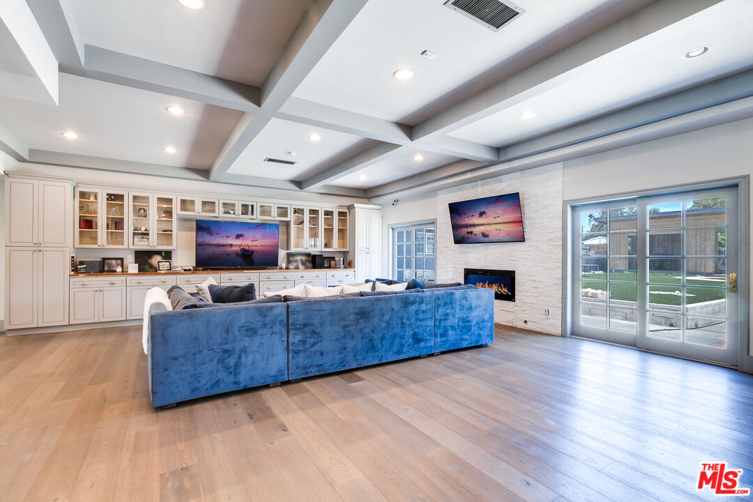 17153 Rayen Street Northridge, CA 91325 - Photo 4 of 47 a living room with furniture and a flat screen tv