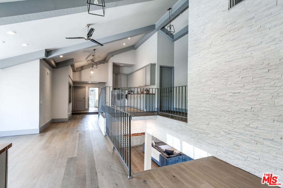 17153 Rayen Street Northridge, CA 91325 - Photo 41 of 47 a view of entryway and hall with wooden floor