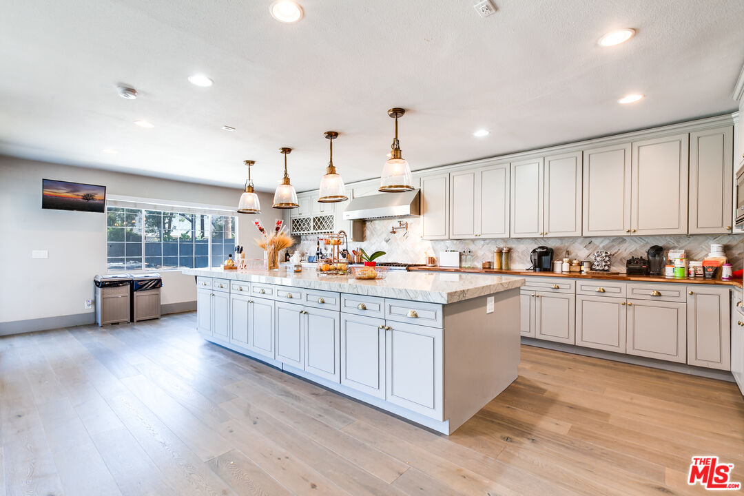 17153 Rayen Street Northridge, CA 91325 - Photo 9 of 47 a kitchen with stainless steel appliances sink refrigerator and cabinets