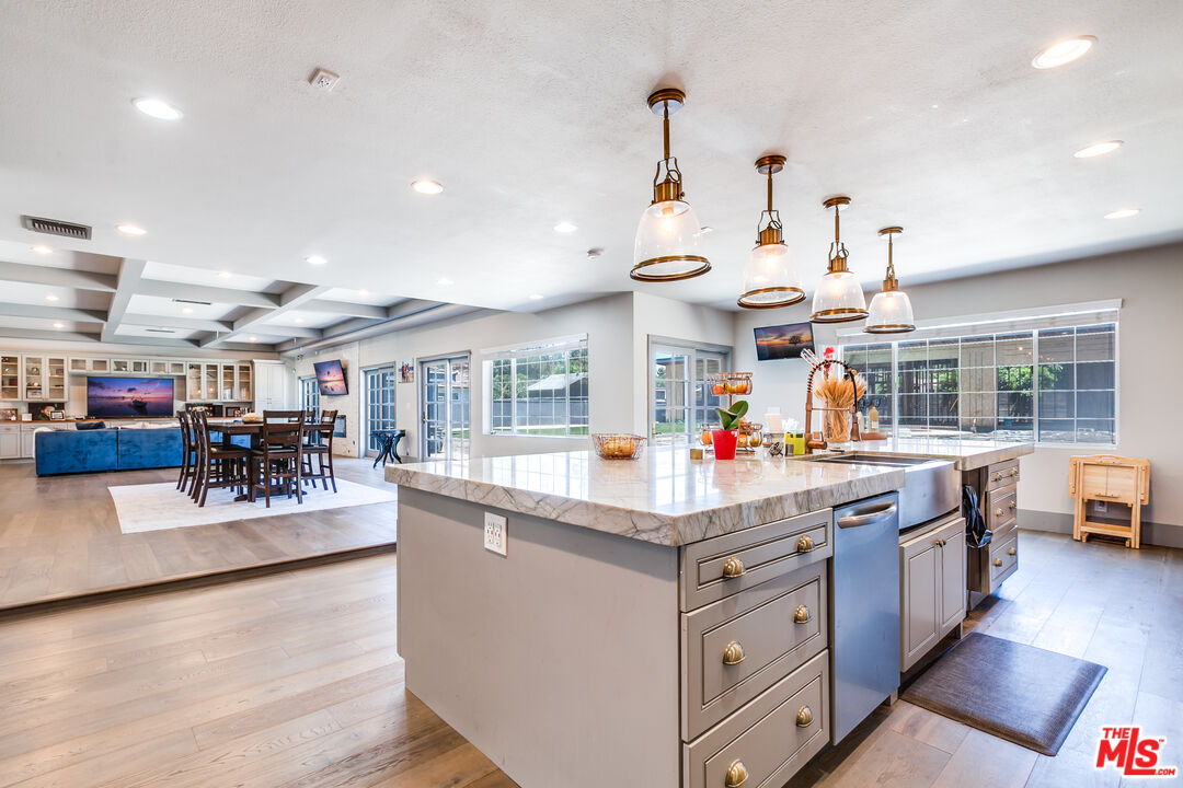 17153 Rayen Street Northridge, CA 91325 - Photo 10 of 47 a kitchen with stainless steel appliances granite countertop a stove and cabinets