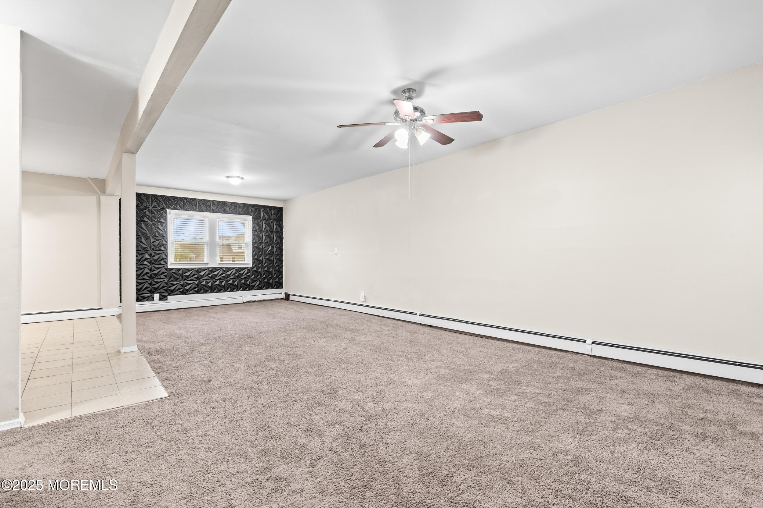 8 West End Court Long Branch, NJ 07740 - Photo 11 of 45 an empty room with chandelier fan and windows