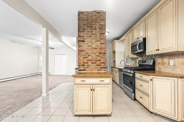 a kitchen with granite countertop white cabinets and white appliances