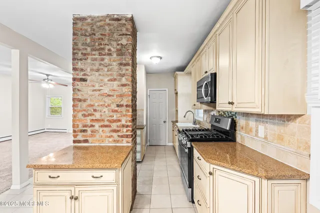 a kitchen with granite countertop a sink and a stove