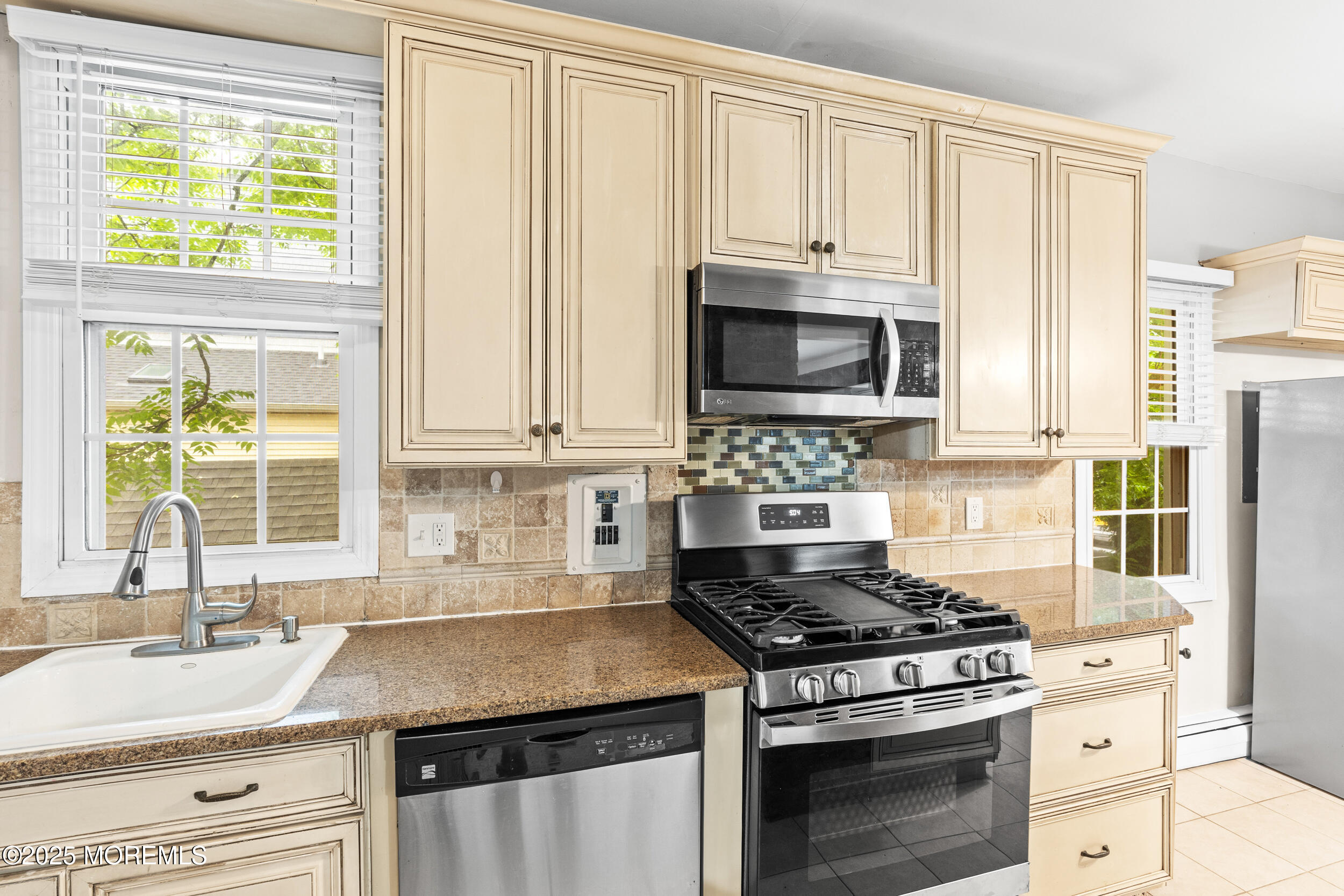 8 West End Court Long Branch, NJ 07740 - Photo 20 of 45 a kitchen with granite countertop a stove a sink and a microwave