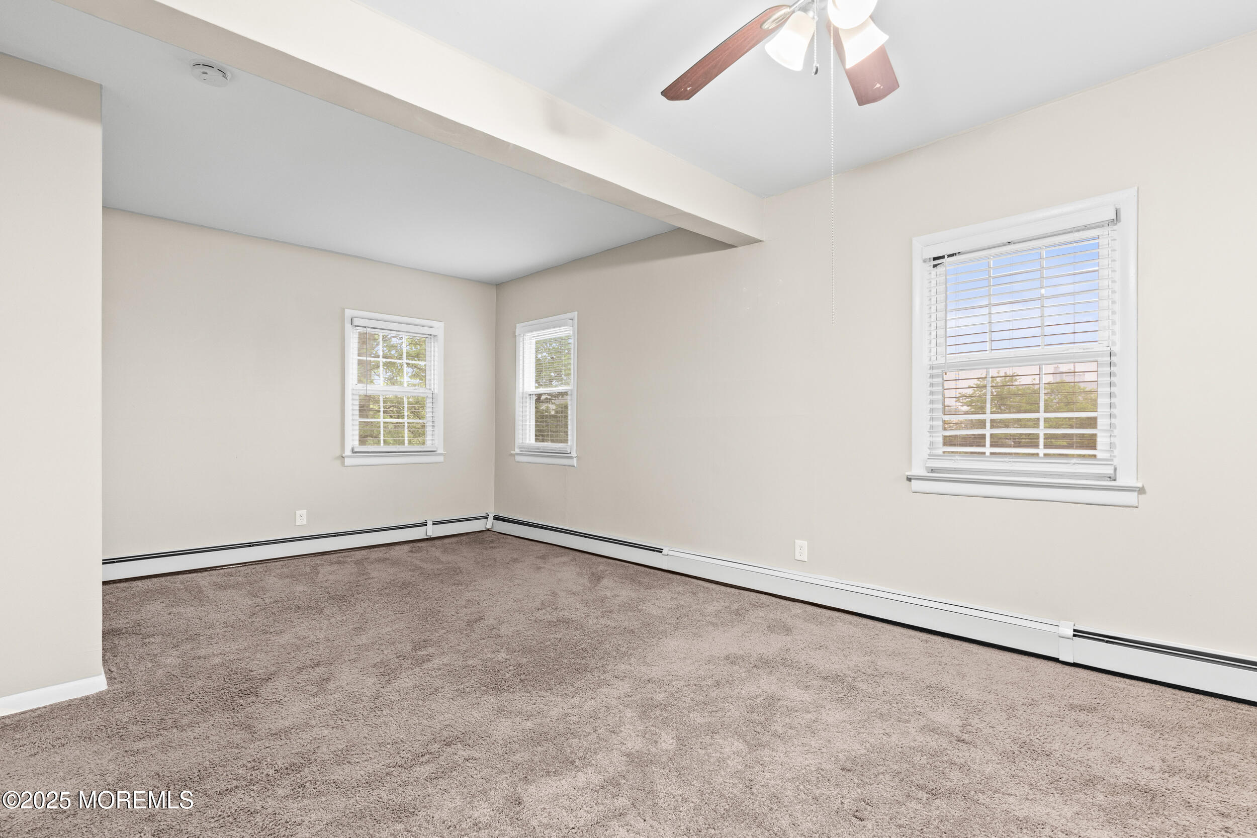 8 West End Court Long Branch, NJ 07740 - Photo 21 of 45 an empty room with windows and fan