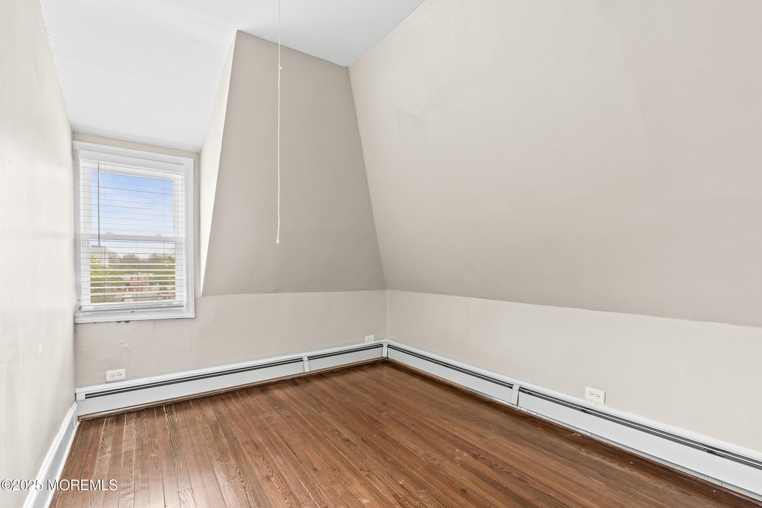 8 West End Court Long Branch, NJ 07740 - Photo 27 of 45 a view of an empty room with wooden floor and a window