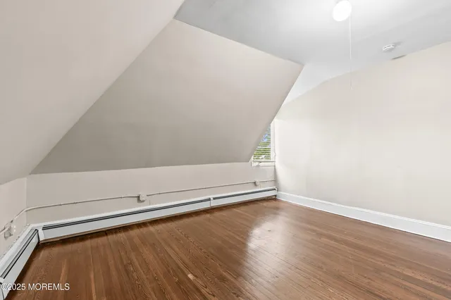 an empty room with wooden floor