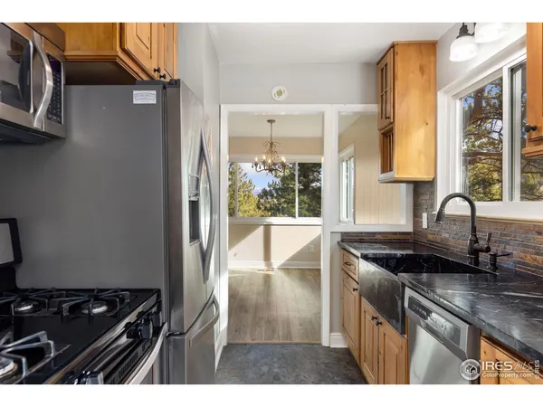 a kitchen with a sink and a stove next to a window