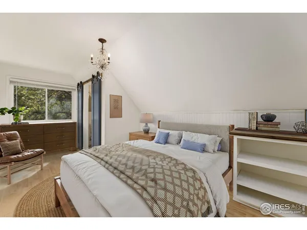 a bedroom with a bed and a tv