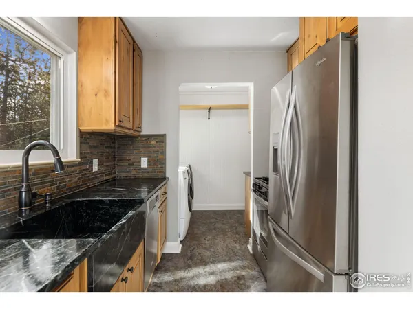 a kitchen with a refrigerator and a sink