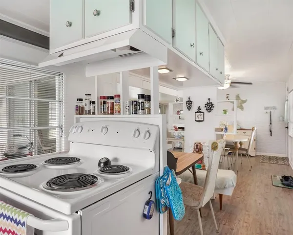 a kitchen with a stove and white cabinets