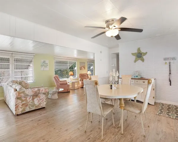 a view of a dining room with furniture and chandelier