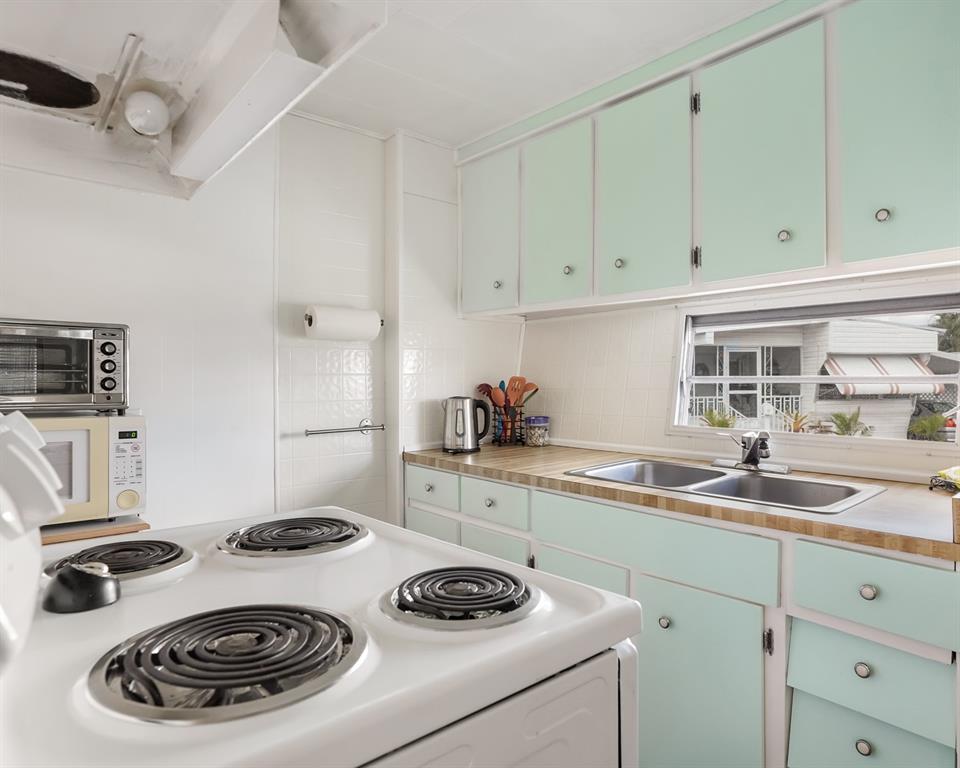 Park City Davie, FL 33324 - Photo 2 of 26 a kitchen with a sink a stove and cabinets