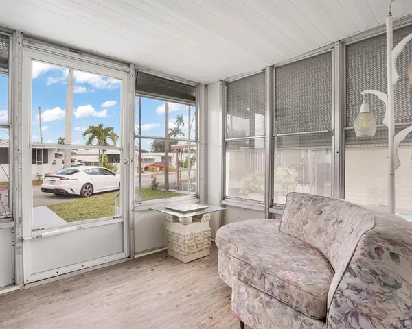 a living room with furniture and a large window with outer view