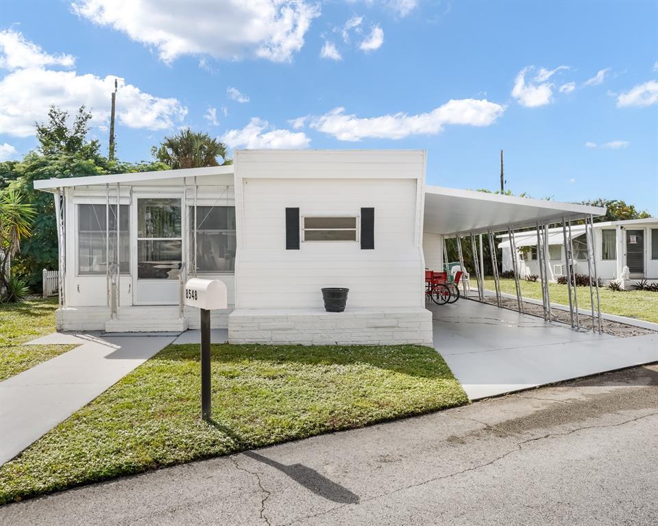 Park City Davie, FL 33324 - Photo 10 of 26 a front view of a house with a yard
