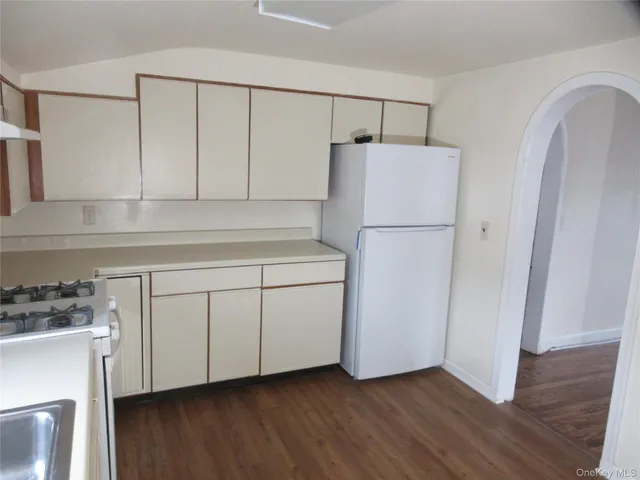 a white refrigerator freezer sitting inside of a kitchen
