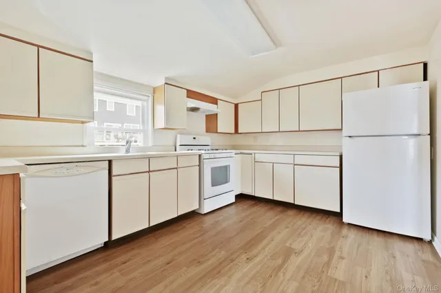 a kitchen with white cabinets sink and white appliances