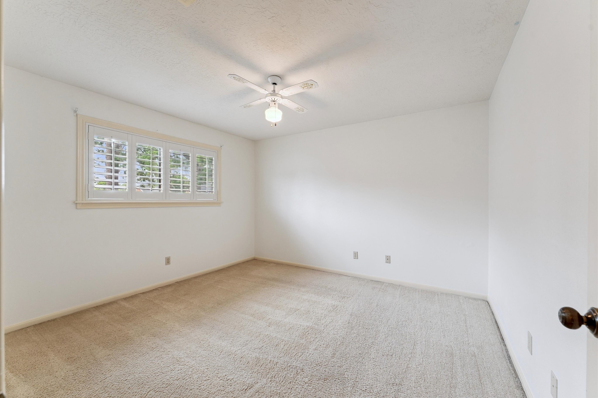8015 Democracy Court Spring, TX 77379 - Photo 14 of 21 an empty room with a window and ceiling fan