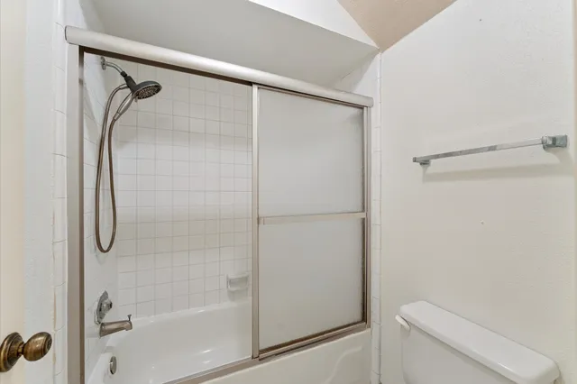 a bathroom with a shower and a toilet