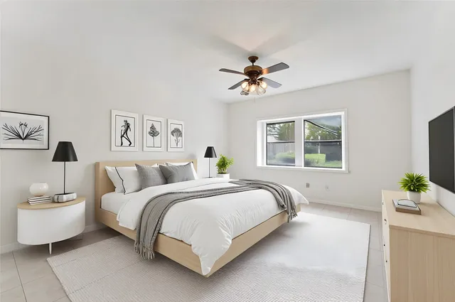a bedroom with a bed and a chandelier