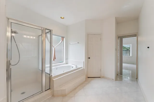 a bathroom with a tub shower and sink