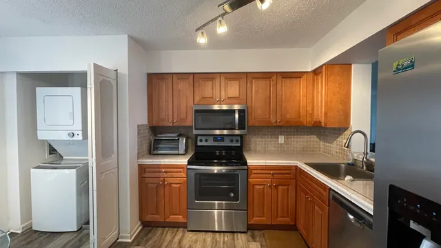a kitchen with a sink a stove and refrigerator
