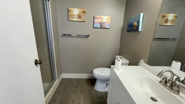 a white toilet sitting next to a bathroom sink