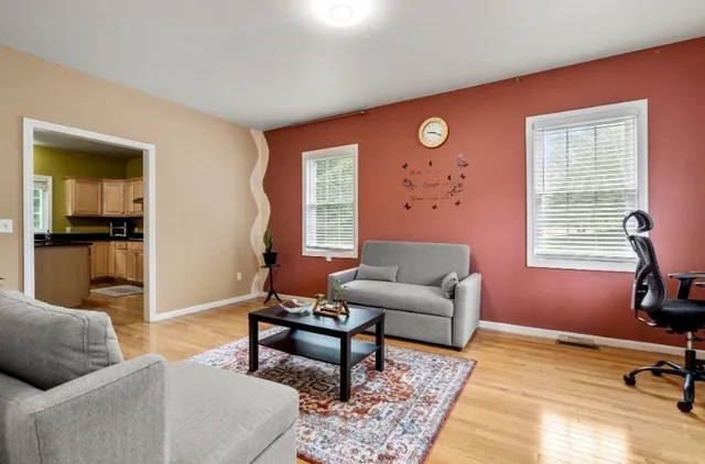 a living room with furniture and wooden floor