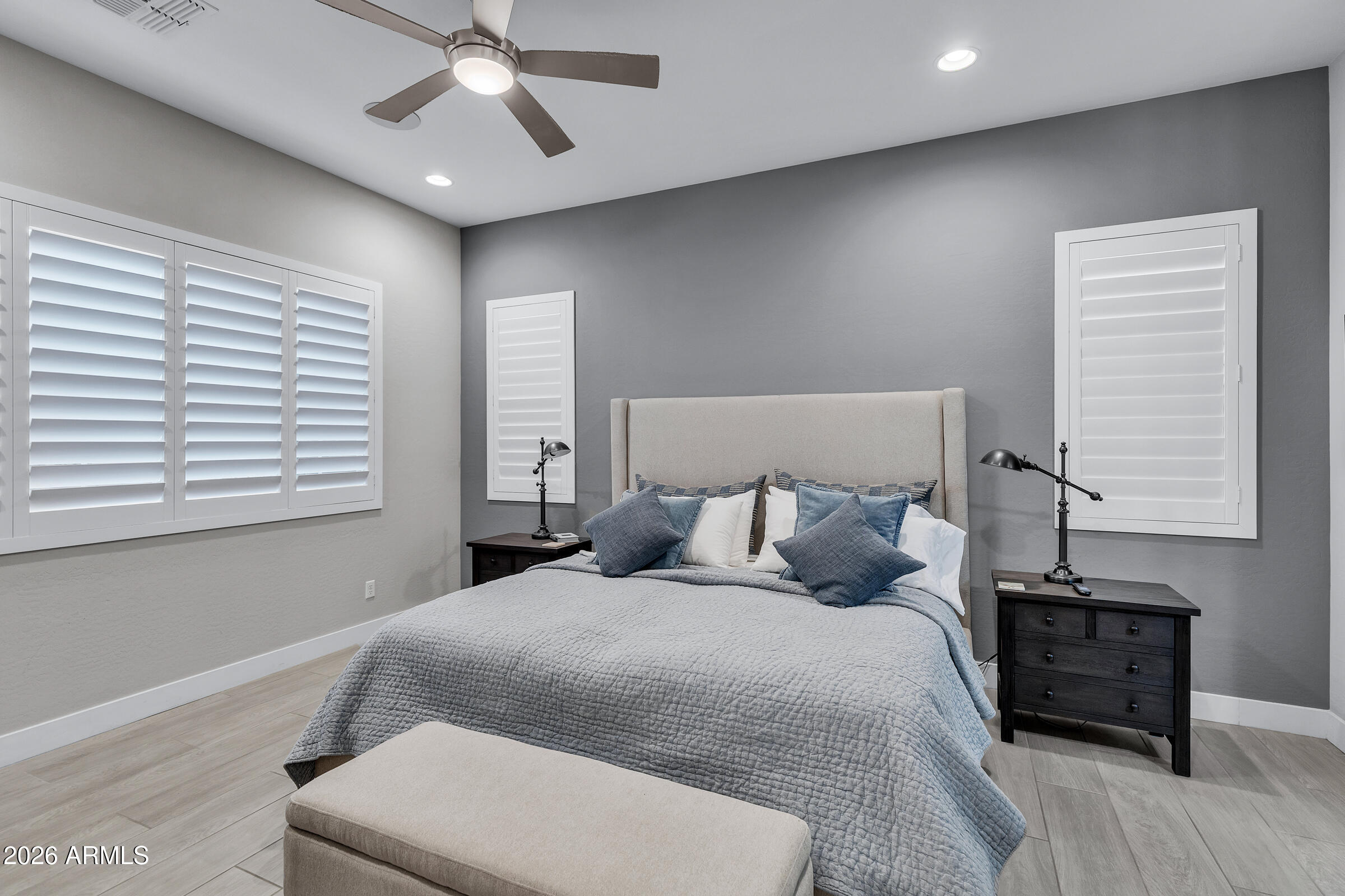 622 West Deer Creek Road Phoenix, AZ 85048 - Photo 21 of 39 a bedroom with a large bed and a chandelier