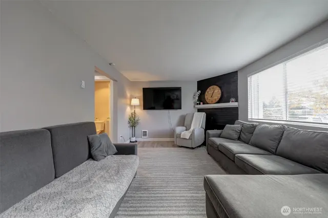 a living room with furniture window and a fireplace