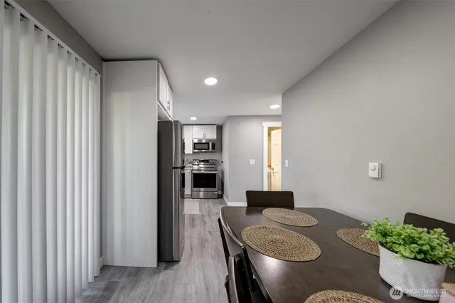 a dining room with furniture and wooden floor
