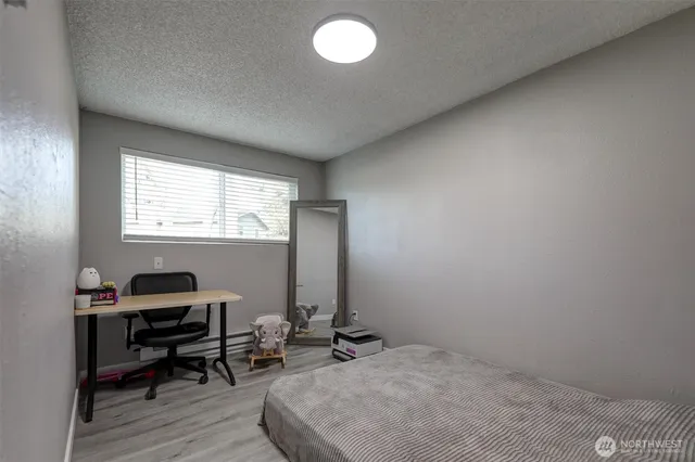 a bedroom with bed and a window