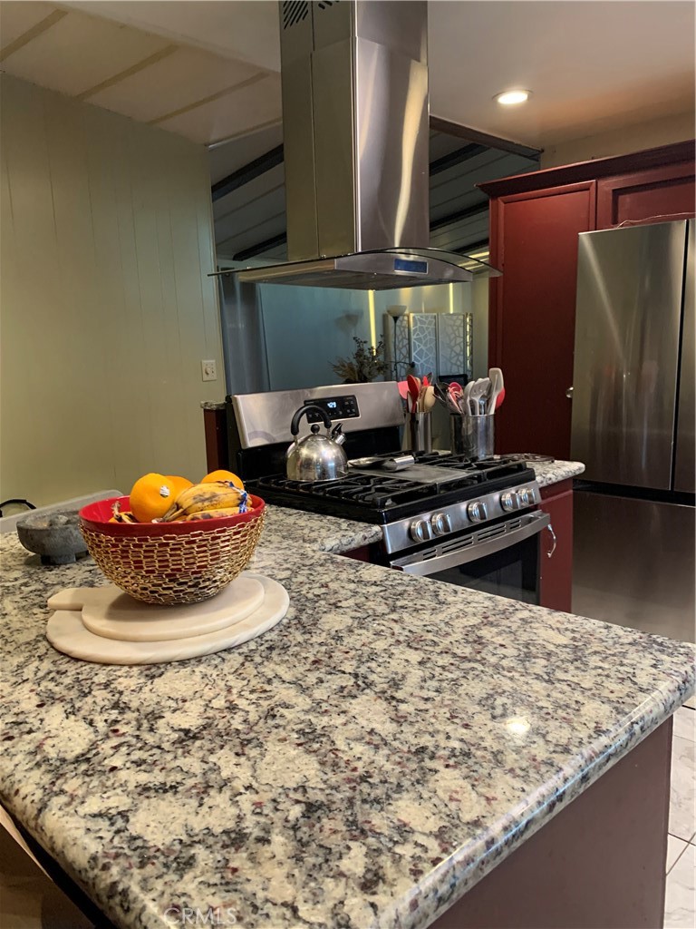 19009 South Laurel Park Road, Unit 248 Rancho Dominguez, CA 90220 - Photo 11 of 20 a kitchen with a stove and a refrigerator