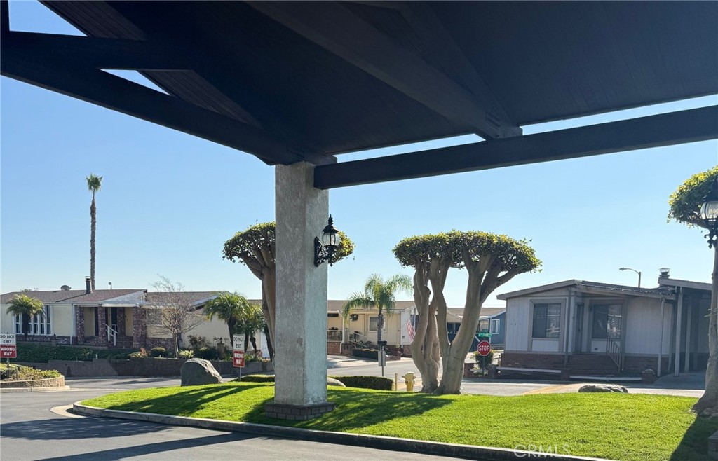 19009 South Laurel Park Road, Unit 248 Rancho Dominguez, CA 90220 - Photo 15 of 20 a front view of a house with garden