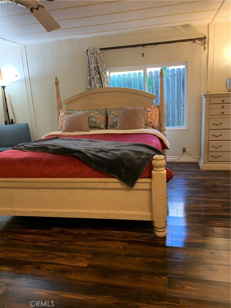 19009 South Laurel Park Road, Unit 248 Rancho Dominguez, CA 90220 - Photo 10 of 20 a bedroom with a bed and wooden floor