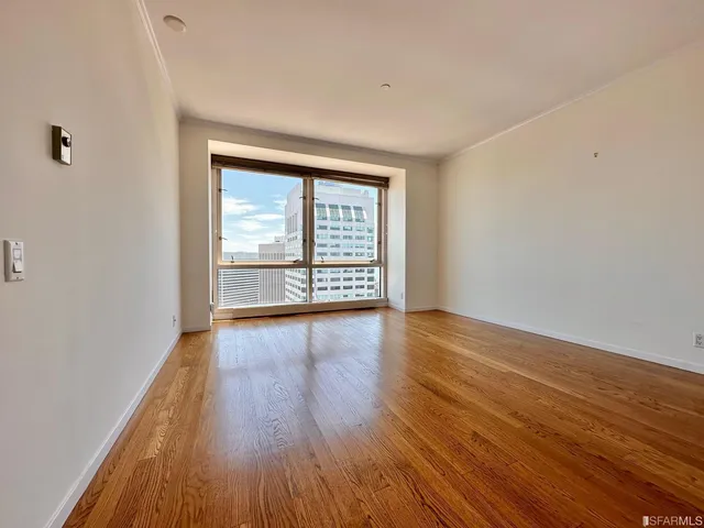 wooden floor in an empty room with a window