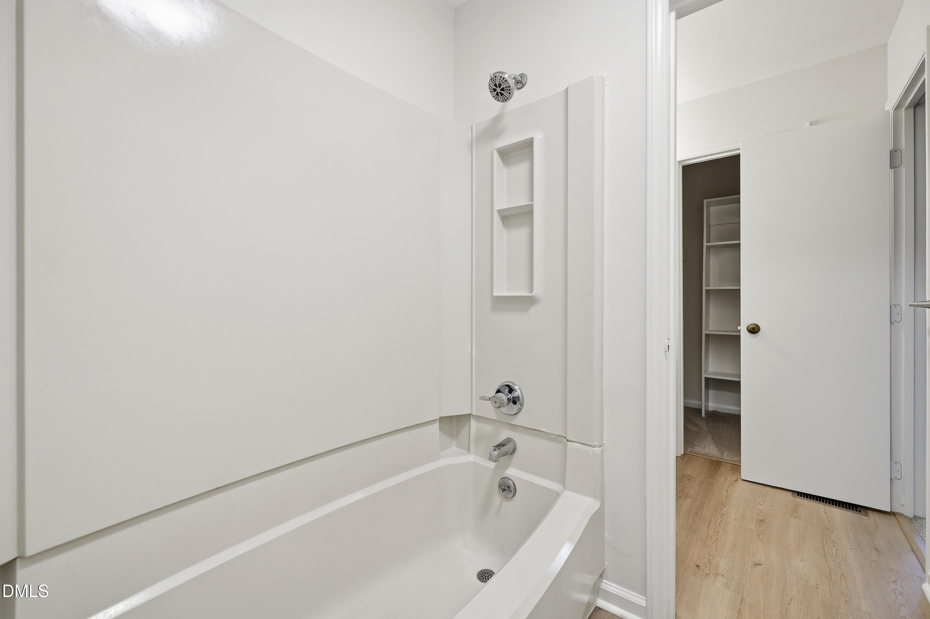 669 Bashford Road Raleigh, NC 27606 - Photo 10 of 19 a white bath tub sitting next to a shower