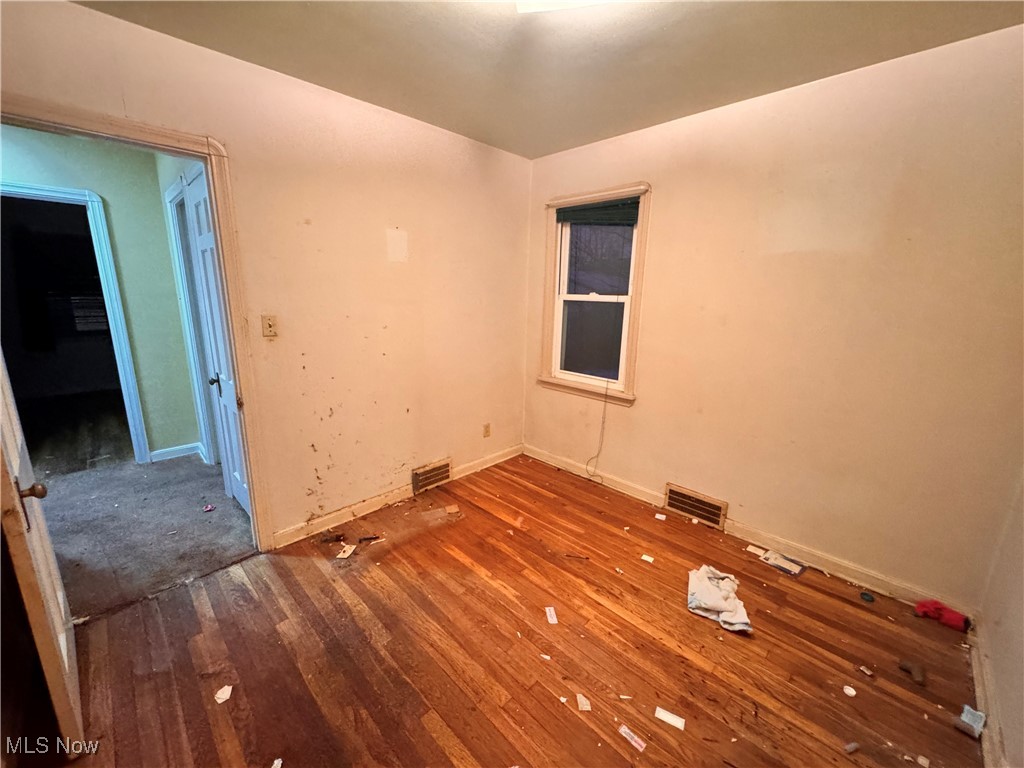 4770 Burleigh Road Cleveland, OH 44125 - Photo 10 of 22 Empty room with hardwood / wood-style flooring and baseboards