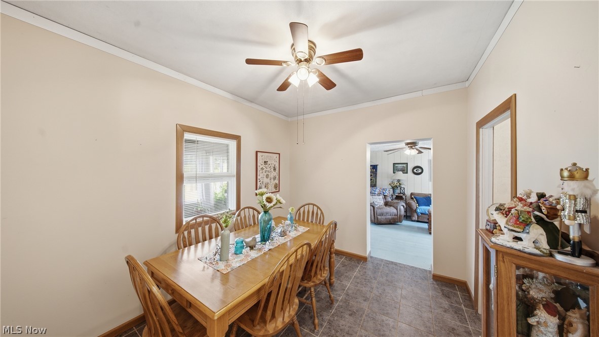 89 Dagg Road Parkersburg, WV 26101 - Photo 20 of 45 Dining area featuring tile flooring, a ceiling fan with integrated lighting, and a wood-trimmed window