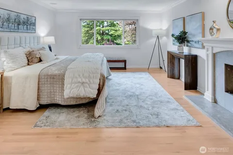 a bedroom with a bed a mirror and a window