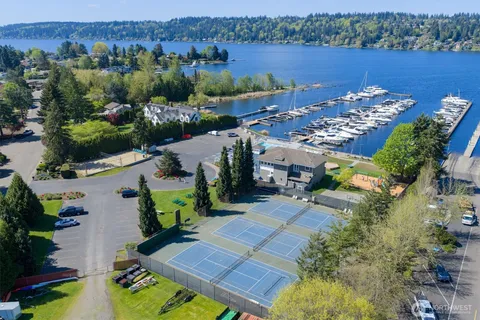 an aerial view of a house with a garden and lake view